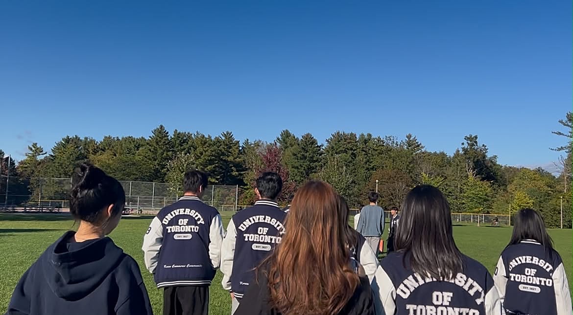 Members in matching varsity jackets on the field